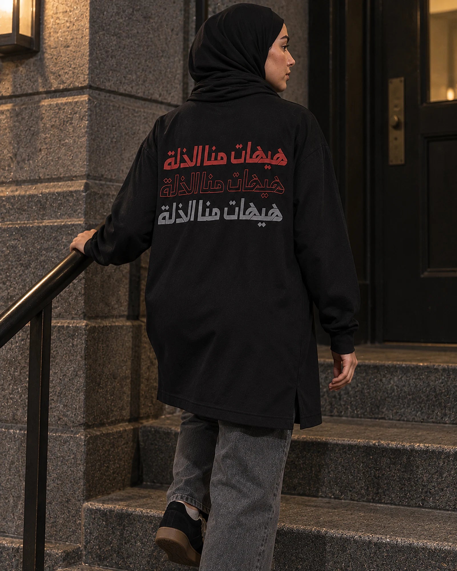 Never to Humiliation women's shirt, walking down stone steps